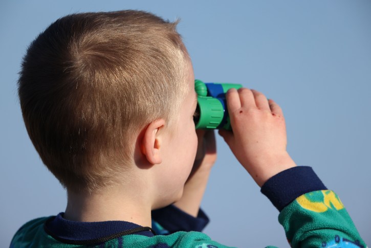A boy holding binoculars